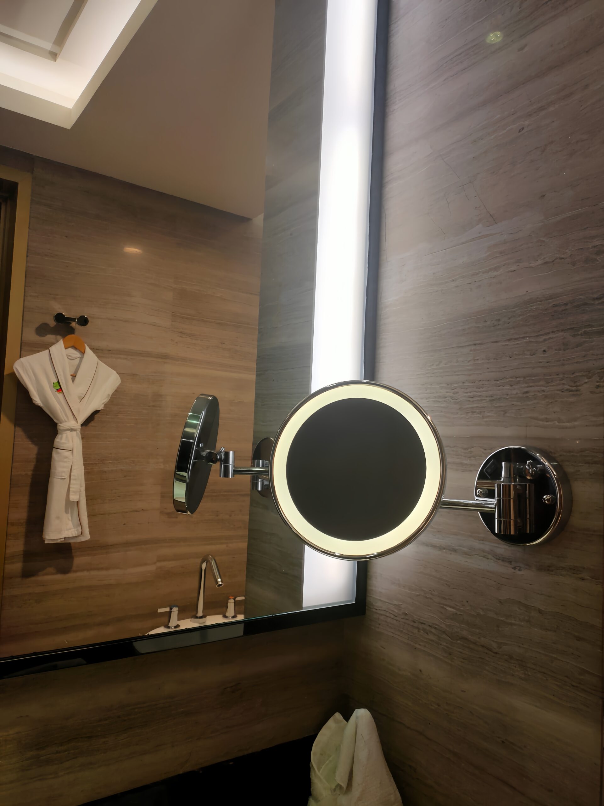 LED wall mounted makeup mirror in a hotel bathroom