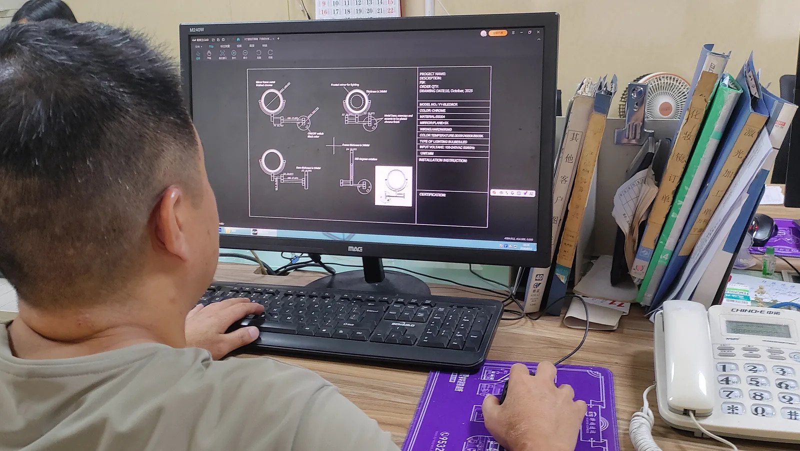 Engineer working on the mirror's technical design drawing